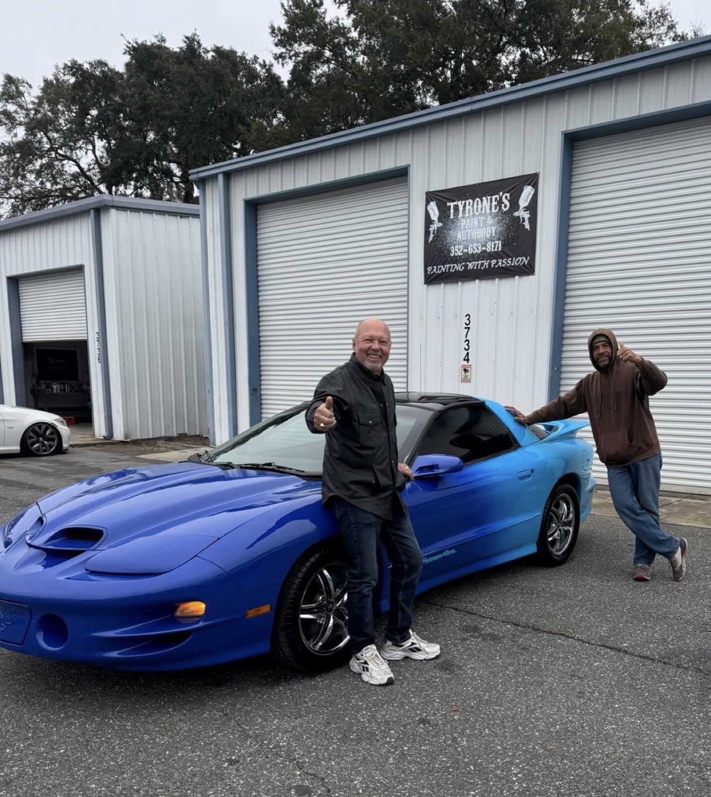 Blue Trans Am in front of Tyrone's shop, 3734